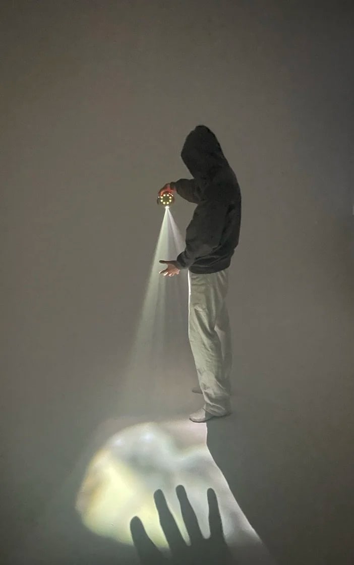 the Stem Projector in a hand, throwing light onto the floor